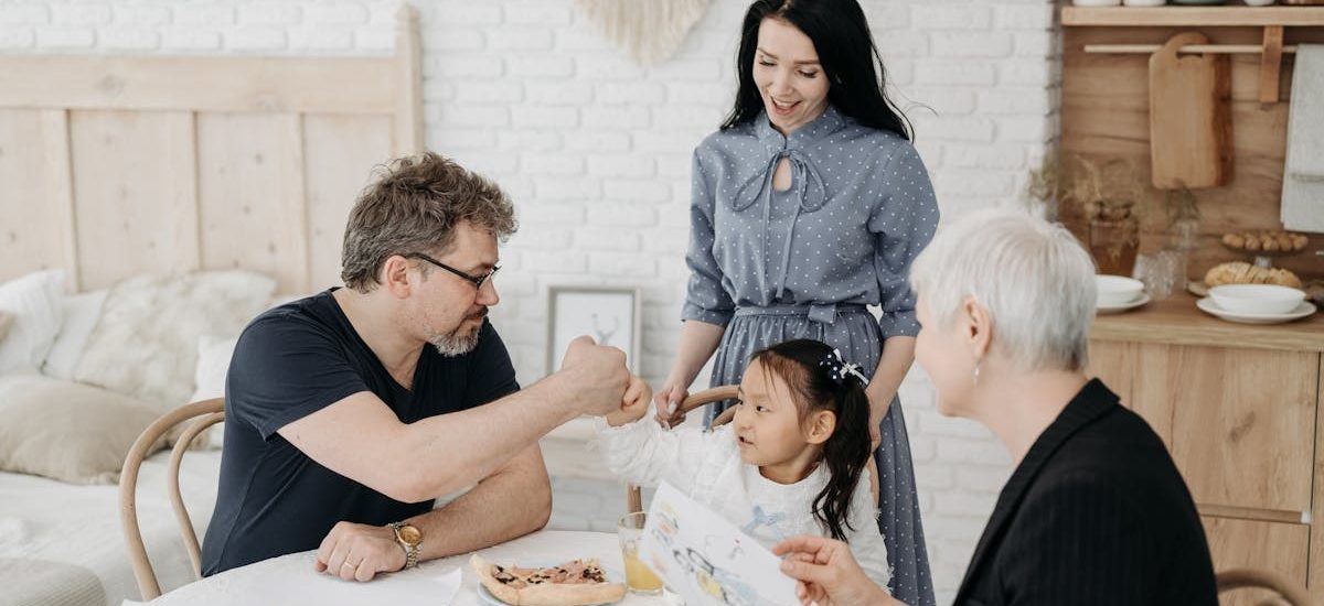 Child with foster parents and a social worker discussing adoption at home.